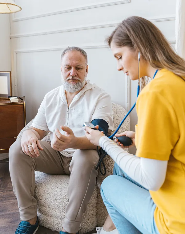 Caregiver taking senior client blood pressure