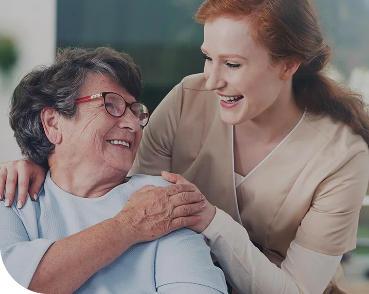 Caregiver smiling with senior client